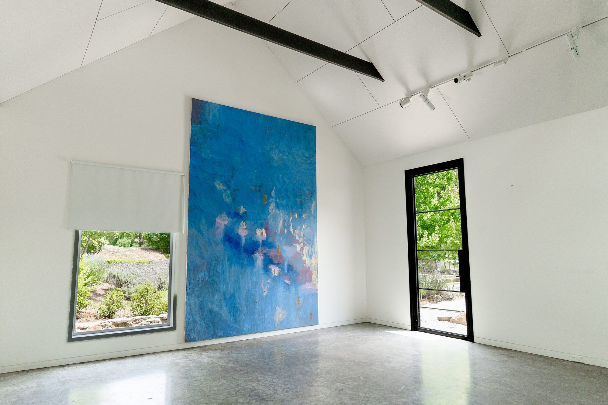 Gallery room with large blue abstract painting